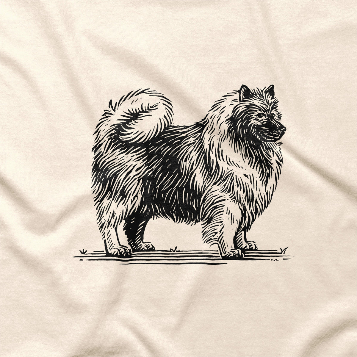 Natural T-shirt detail showing a large black Keeshond illustration