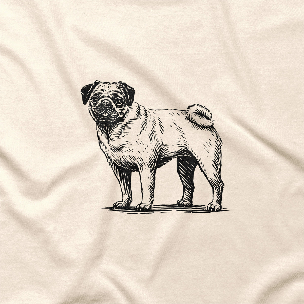 Natural T-shirt fabric close-up showing a detailed black pug illustration